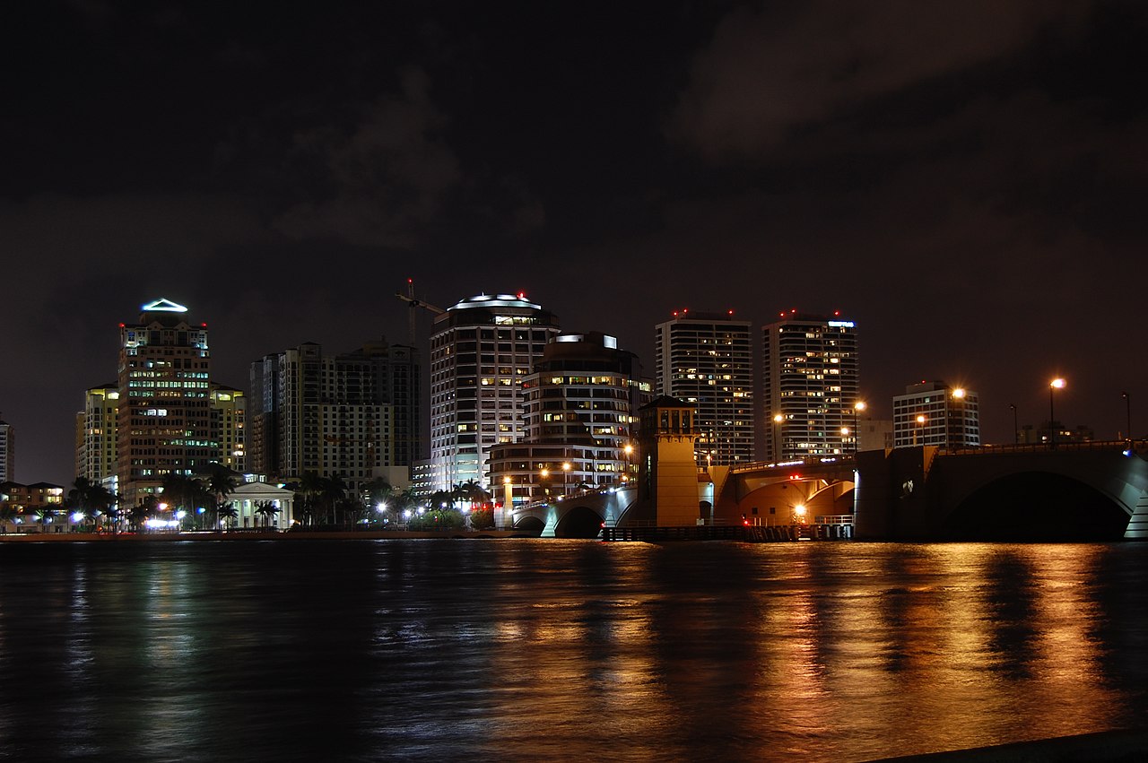 West Palm Beach skyline lit up at night, seen from the water